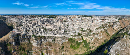 Aerial view of the ancient town of Matera (Sassi di Matera) in beautiful Basilicata, southern Italy. ancient cave houses carved into the tufa rock over the deep ravine, Gravina River.の写真素材