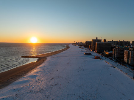 Aerial view of a snow covered Coney Island Beach during the winter at sunset in Brooklyn, New Yorkの写真素材