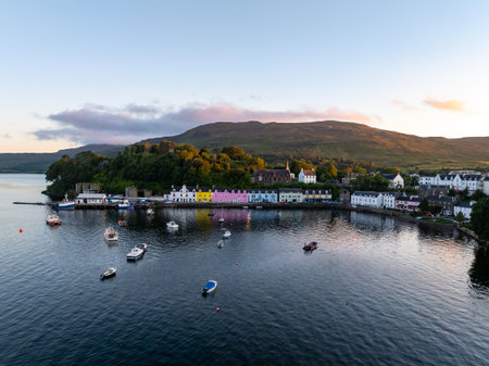 Portree, UK - Jul 8, 2024: Beautifully painted houses aligned along the harbour in Portree, UK.の写真素材