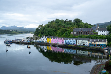 Portree, UK - Jul 7, 2024: Beautifully painted houses aligned along the harbour in Portree, UK.の写真素材