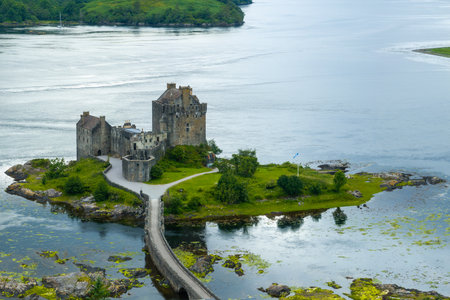 Eilean Donan castle with connecting footbridge on a tidal island between Loch Duich, Loch Long and...