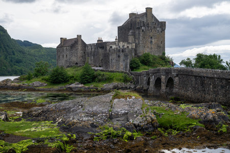 Eilean Donan castle with connecting footbridge on a tidal island between Loch Duich, Loch Long and...