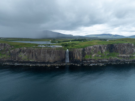 Aerial view of the dramatic coastline at the cliffs by Staffin with the famous Kilt Rock waterfall - Isle of Skye - Scotland.の写真素材