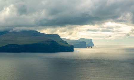 Background of Risin og Kellingin rocks and cliffs of Eysturoy and Streymoy Islands seen view point near Kallur lighthouse on the Kalsoy Island. Faroe Islands, Denmark.の写真素材