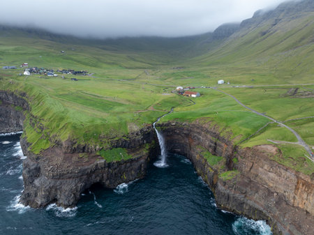 Aerial view of Gasadalur Village and Mulafossur Waterfall in the Faroe Islands.の写真素材