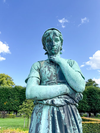 Copenhagen, Denmark - Jul 27, 2024: Statue of Danish girl (Liden Gunver 1899) in Rosenborg Castle Gardens (Danish: Kongens Have) in Copenhagen, Denmark.の写真素材