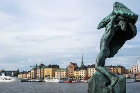 Stockholm, Sweden - Aug 8, 2024: Wings Statue by Milles. Is called Vingar or The Wings. Gamla Stan in the background.の写真素材