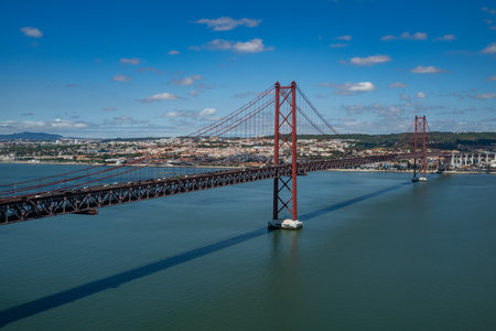 The 25 de Abril Bridge is a bridge connecting the city of Lisbon to the municipality of Almada on the left bank of the Tejo river, Lisbonの写真素材