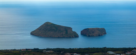 Small islets in coastline of Terceira Island in Azores called Ilheus das Cabras, Goat Islets.の写真素材