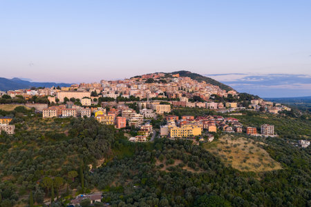 An aerial view of the historic town of Tivoli surrounded by mountains in Italy at sunset.の写真素材