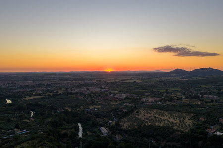 An aerial view from the historic town of Tivoli surrounded by mountains in Italy at sunset.の写真素材