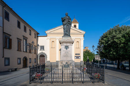 Monument to Saint Bonaventure in Civita di Bagnoregio, Italy, lit by afternoon sun against a vibrant blue sky, with historic architecture in the backdrop creating a serene and timeless scene.の写真素材