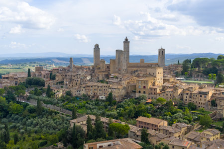 Aerial view of San Gimignanoâs medieval tower houses rising above Tuscan hills, a former Via Francigena trading center and UNESCO site.の写真素材