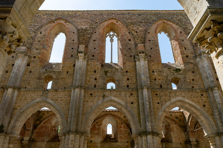 Interior Gothic arches and pointed windows of the roofless Cistercian Abbazia di San Galgano near Chiusdino in Tuscany.の写真素材