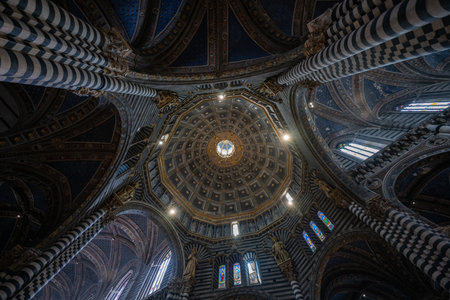 Siena, Italy - Jul 19, 2025: Siena Cathedral's intricate dome features alternating black and white marble, typical of Italian Gothic architecture.の写真素材
