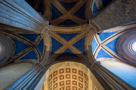 Orvieto, Italy - Jul 14, 2025: Gothic-style nave of Church of Sant'Andrea, Orvieto, with ribbed vaults, stone columns, intricate pulpit, and dim natural light.の写真素材