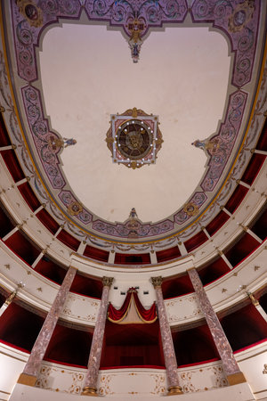 Volterra, Italy - Jul 21, 2025: Upward view of the ornate neoclassical ceiling, balconies and marble columns inside Teatro Persio Flacco in Volterra, Tuscany.の写真素材