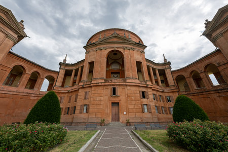 Low-angle view of the Baroque brick facade of the Sanctuary of Our Lady of San Luca on Colle della...