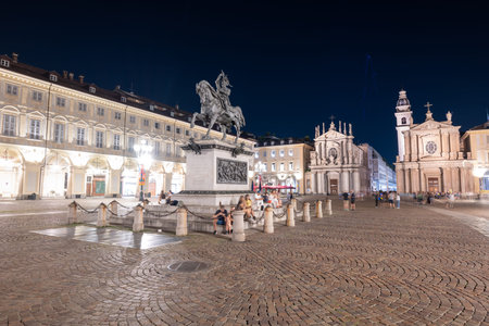 Turin, Italy - Aug 9, 2025: Night view of Piazza San Carlo in Turin with the 19th-century equestrian statue of Emanuele Filiberto and twin Baroque churches.の写真素材