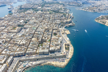 High-angle aerial photo of Vallettas dense limestone city grid on a fortified peninsula, bordered by...