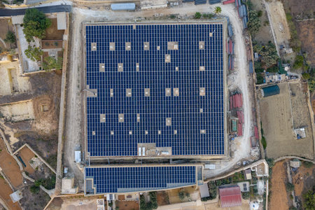Aerial view of Ta' Cenc Reservoir in Sannat, Malta, showing a rectangular water basin covered with...