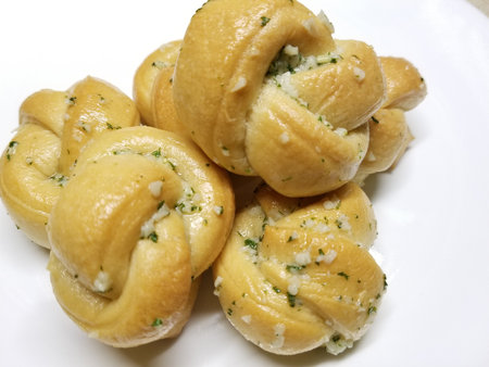 Delicious home made garlic knots on a white backgroundの写真素材