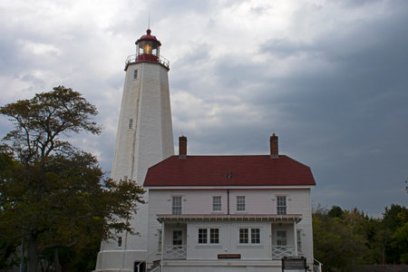 Lighthouse at Sandy Hook, New Jersey, at dusk on a cloudy day with its light shining dimly -30の写真素材