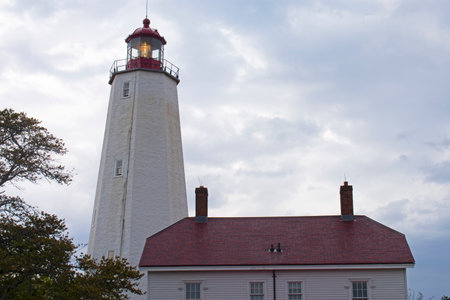 Lighthouse at Sandy Hook, New Jersey, at dusk on a cloudy day with its light shining dimly -31の写真素材