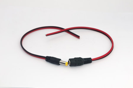 DC 12V male and female connector cables isolated on white background. Electronic parts used by...