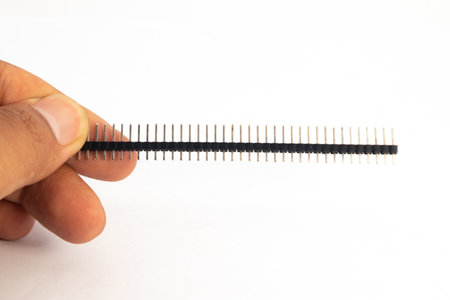 A header module of the jumper is held in hand. This module is used for electronics hobbyists for DIY...