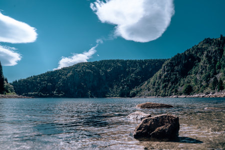 Lake in the mountains with a blue skyの写真素材