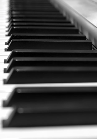 Keyboard of a grand piano: focus on a keys on the centerの写真素材