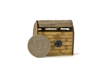 Tiny chest and a coin in real scaleの写真素材
