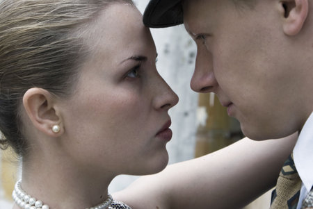 Beautiful stylish girl and the man in a business suit steadfastly look each other in the faceの写真素材