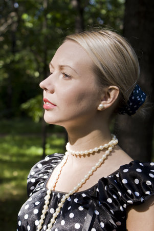 Beautiful girl in sunglasses on a foliage background の写真素材