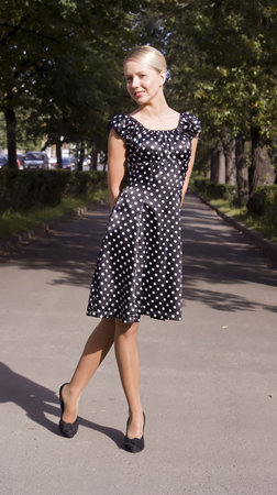 Beautiful girl in a retro style on city streetsの写真素材