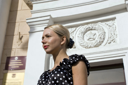 The beautiful stylish girl on a background of establishment with the Soviet symbolicsの写真素材