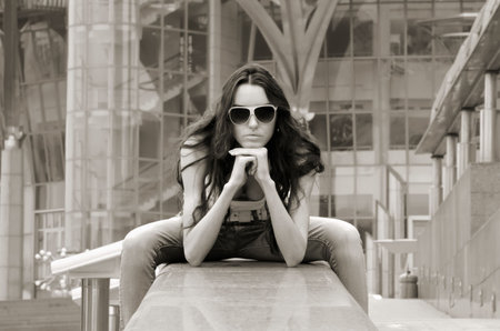 The young girl on a background of a city landscape in business quarter
 の写真素材