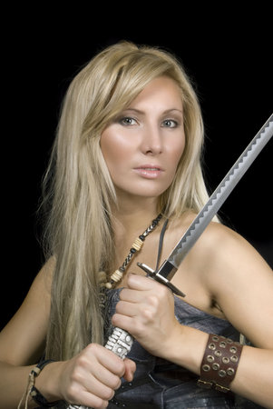Portrait of the attractive girl with a sword on a black background
 の写真素材
