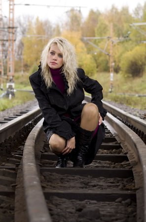 Beautiful woman on railway tracksの写真素材