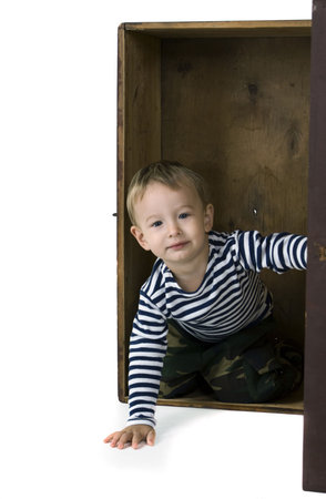 The little boy looks out of the big boxの写真素材