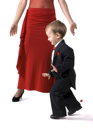The little boy in a suit tiptoesの写真素材