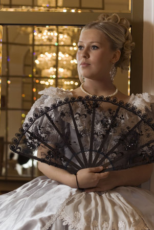 Picture of young attractive girl in ball gowns with a fan