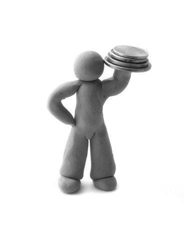 Way to success. The plasticine human figure holds a pile of coinsの写真素材
