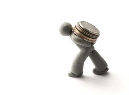 Heavy money. The plasticine human figure carries coins
の写真素材