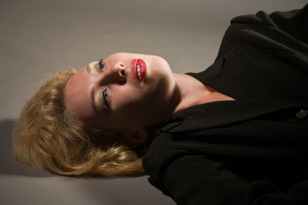 Lifeless young woman lays on the floorの写真素材