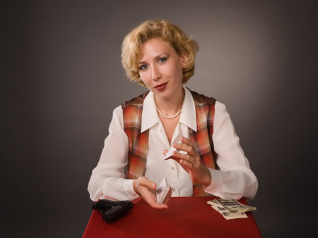 The pretty woman with cards on a grey backgroundの写真素材