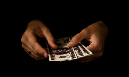 women's hands with packs of dollars over blackの写真素材