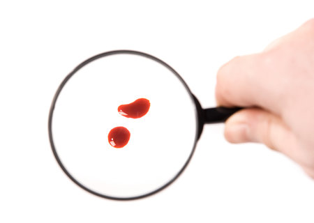 magnifying glass and blood drops over white backgroundの写真素材