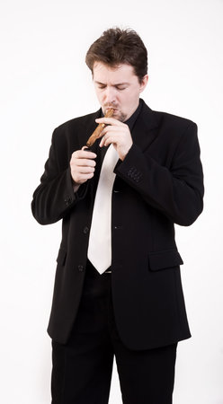 Business man in black suit smokes a cigarの写真素材